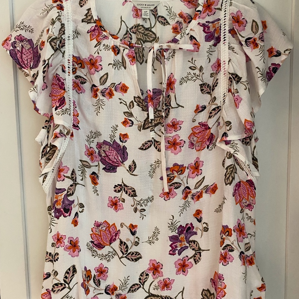 Lucky flirty floral top.  White with pinks. Light weight. Keyhole neck.